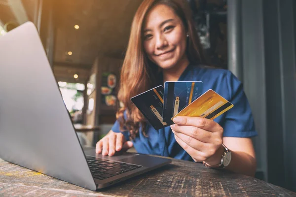 Una Hermosa Mujer Asiática Sosteniendo Tarjetas Crédito Mientras Usa Computadora —  Fotos de Stock