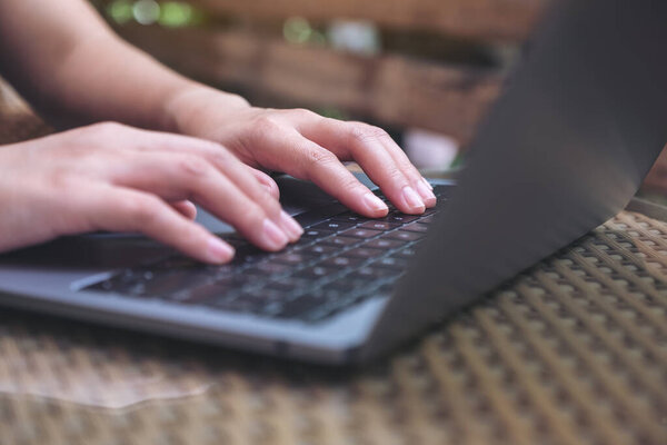 Closeup image of hand using and typing on laptop keyboard 