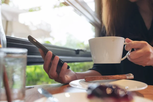 Closeup Image Woman Holding Using Touching Smart Phone While Drinking — Stock Photo, Image