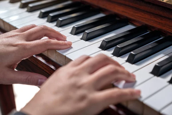 stock image Closeup image of hands playing a vintage wooden grand piano