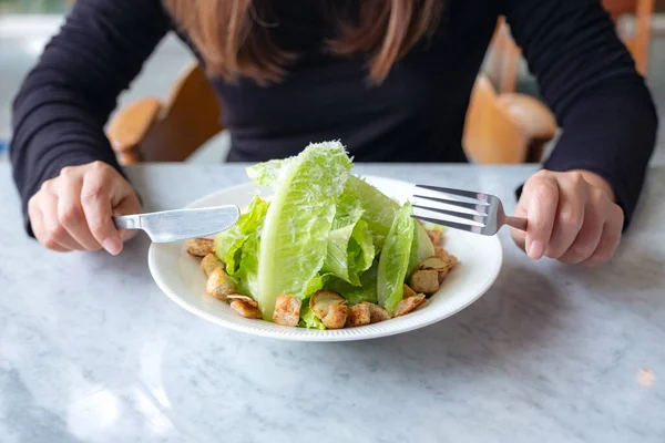 Closeup Image Woman Eating Caesar Salad Knife Fork Table Restaurant — Stock Photo, Image