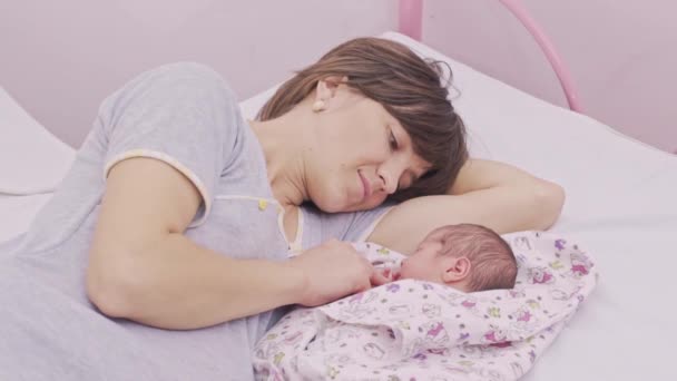 Young Mom Lies With Her Newborn — Stock Video