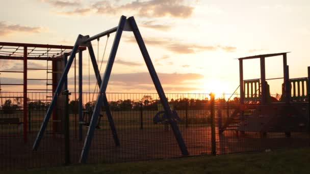 Empty Playground Sunset Swings Swaying — Stock Video