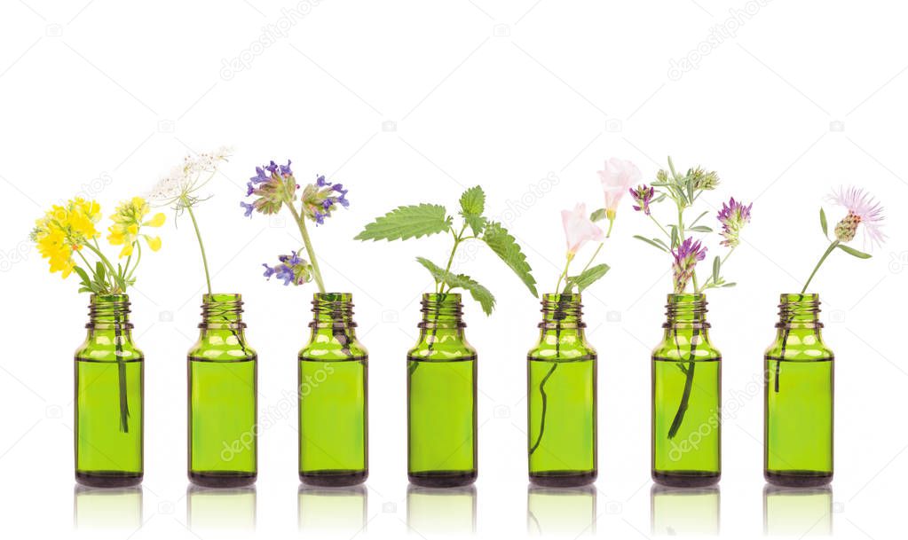 Natural remedies, aromatherapy - bottle. Bottles of essential oil with herbs holy flower.