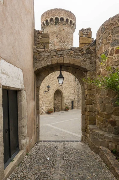 Stone arch and entrance of a castle in Tossa de Mar, Spain