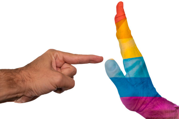 Finger pointing to a peaceful hand with pride flag isolated on a white background. Intolerance against gay community and discrimination concept.