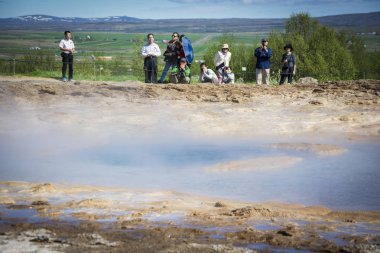 İzlanda, Haziran 2013: Çinli turist ziyaret Strokkur şofben