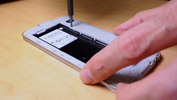 Close up of hands repairing or disassembling a mobile phone — Stock Video