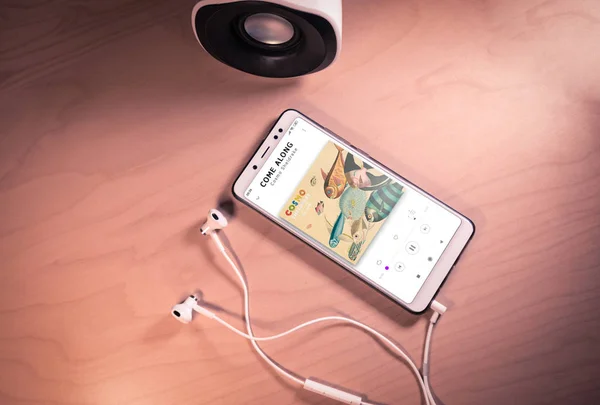 Top view image of smartphone,earphones and speaker with Cosmo Sheldrakes song on screen — Stock Photo, Image