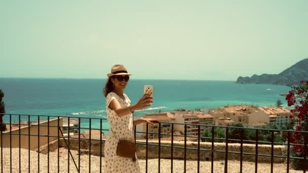 Woman making a selfie, face time or taking a photo. Tourist in Altea, Spain — Stock Video