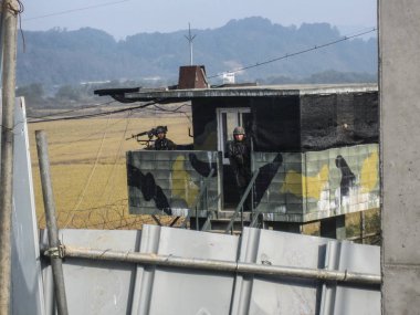 DMZ, South Korea. October 2012: South Korean soldiers standing guard at the DMZ as viewed from the South Korea side clipart