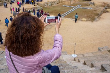 Turist kadın Merida Roma Amfitiyatrosu bir akıllı telefon ile bir resim çekmek