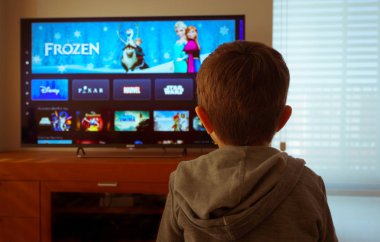 Barselona, İspanya. Mayıs 2019: Tv'de yeni Disney artı platformu izlerken sevimli küçük çocuk geri görünümü