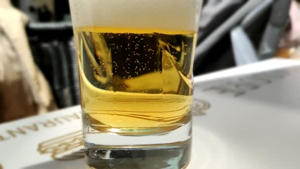 Real beer glass with bubbles in slow motion — Stock Video