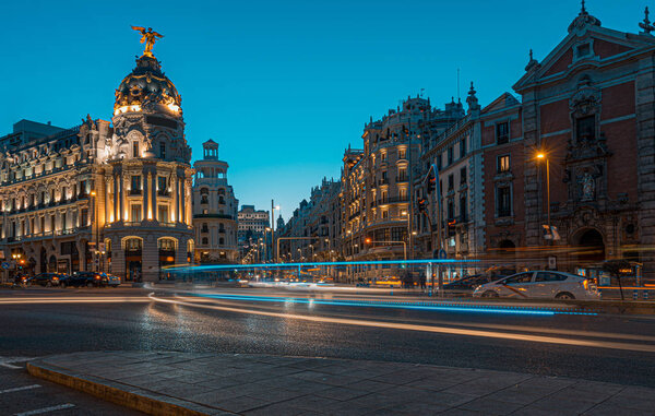 Lighttrails and Traffic on the crossing Alcala and Gran Via street in Madrid by twilight.The Gran Via is unofficially considered main street of Spain capital.