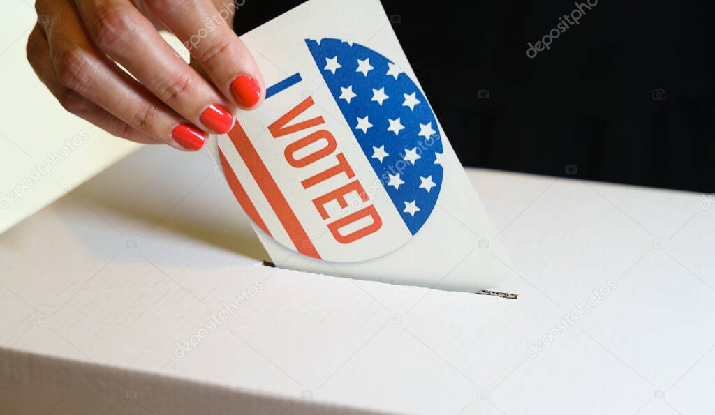 USA elections, Woman voter putting a vote in a ballot box