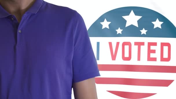 Torso of a citizen standing with folded arms and I Voted waving flag. USA elections — Stock Video