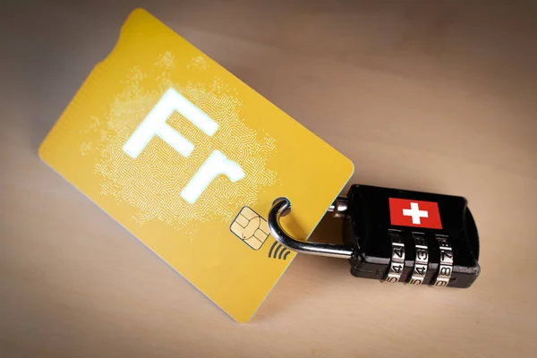 Padlock closed around a credit card with digital Swiss franc on it — Stock Photo, Image