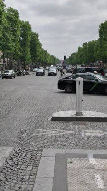 Paris, France. May 14, 2025, Traffic flowing on Champs Elysees avenue in Paris, France