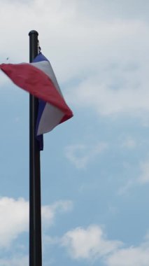 French flag waving in the wind on a cloudy day