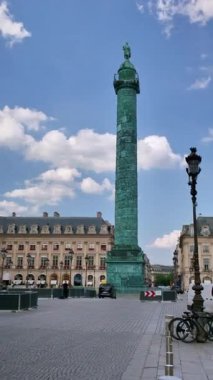 Paris, France. May 14, 2025, Colonne Vendome, a prominent landmark in Paris, stands tall amidst the bustling city traffic