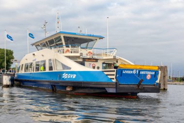 Amsterdam IJ nehrin karşısındaki bir feribot uçaktaki yolcuları