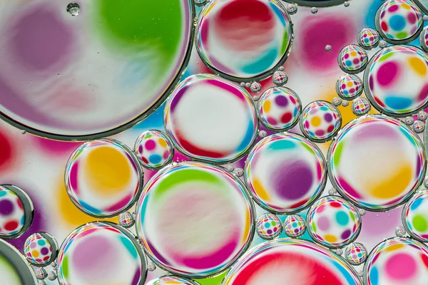 Abstract background of colorful oil drops on water — Stock Photo, Image