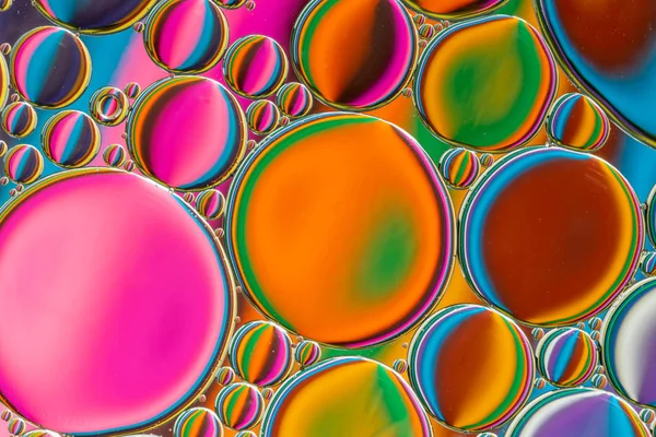 Abstract background of colorful oil drops on water — Stock Photo, Image