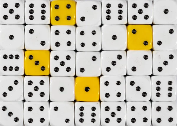 Background of random ordered white dices with four yellow cubes — Stock Photo, Image