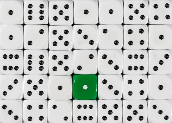 Stock image Background of random ordered white dices with one green cube