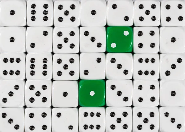 Background of random ordered white dices with two green cubes — Stock Photo, Image