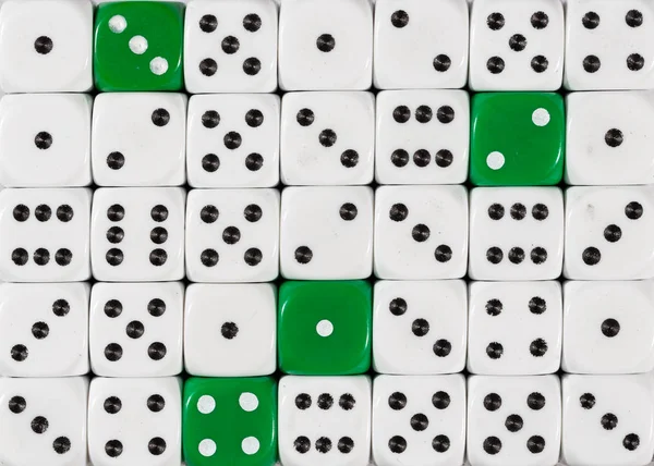 Background of random ordered white dices with four green cubes — Stock Photo, Image