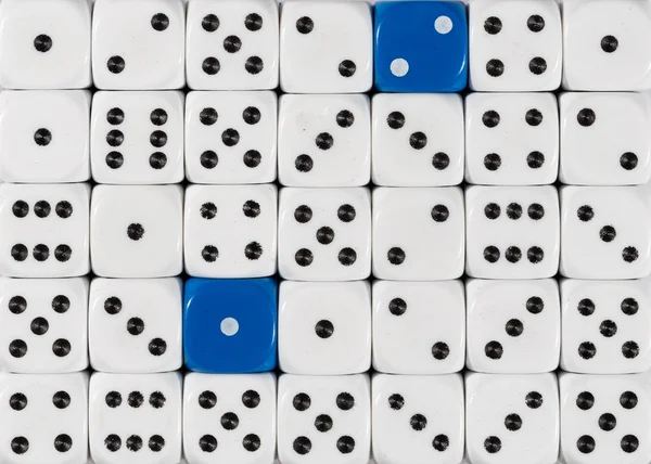 Fondo de dados blancos ordenados al azar con dos cubos azules — Foto de Stock