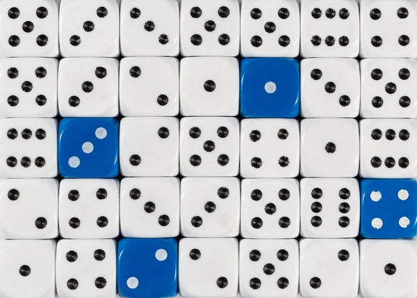 Background of random ordered white dices with four blue cubes — Stock Photo, Image