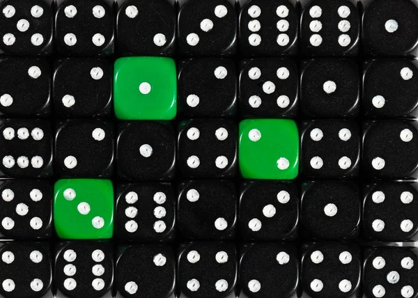 Background of random ordered black dices with three green cubes — Stock Photo, Image