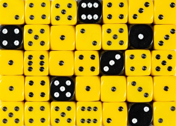 Background of random ordered yellow dices with six black cubes — Stock Photo, Image