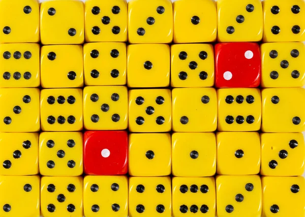 RedBackground of random ordered yellow dices with two red cubes — Stock Photo, Image