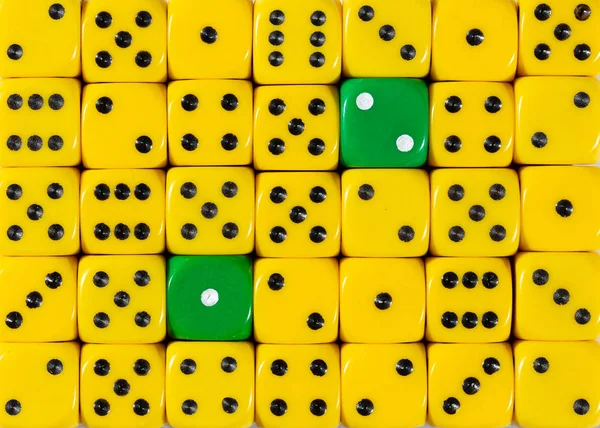 Background of random ordered yellow dices with two green cubes — Stock Photo, Image