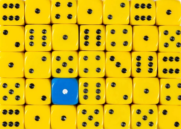Background of random ordered yellow dices with one blue cube — Stock Photo, Image