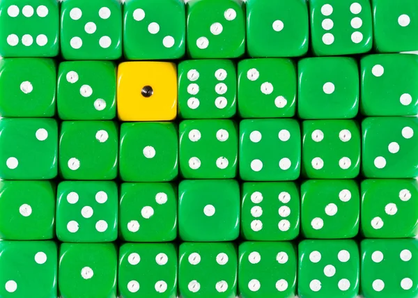 Background of random ordered green dices with one yellow cube — Stock Photo, Image