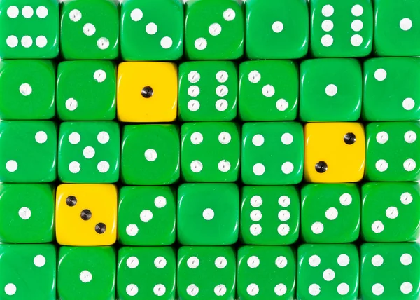 Background of random ordered green dices with three yellow cubes — Stock Photo, Image