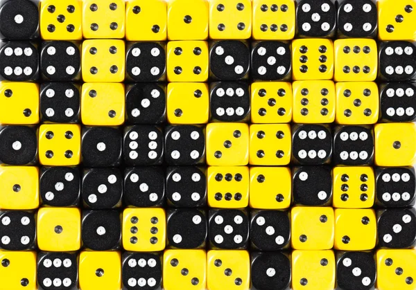 Background of 70 random ordered black and yellow dices — Stock Photo, Image