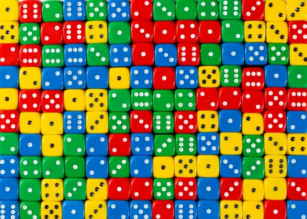 Pattern of random ordered red, yellow, green and blue dices — Stock Photo, Image