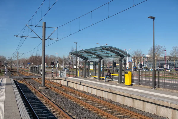 Tram station with with waiting woman in Nieuwegein, the Netherlands — Stock Photo, Image