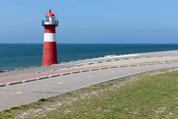 Lighthouse at dike near Westkapelle, the Netherlands — Stock Photo, Image