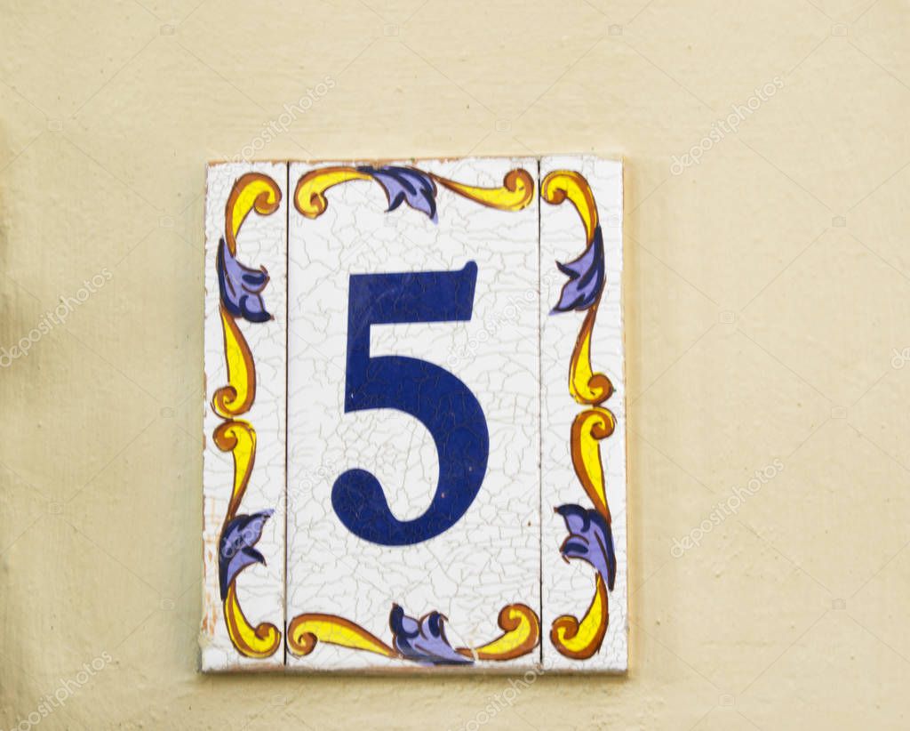 08 08 2108 Atri, Italy - traditional ceramic house plate number 5 on home wall