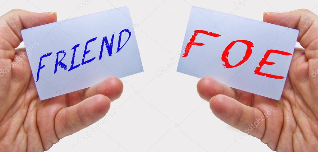 friend or foe choice signs on cards in man hands with a white background. for business concepts