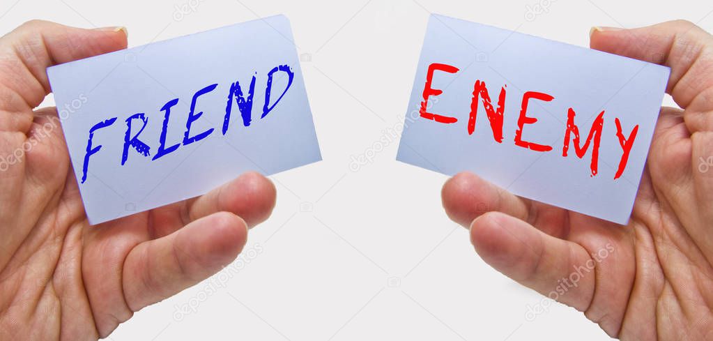 friend and enemy choice cards with man hands on a white background. for business and education concepts