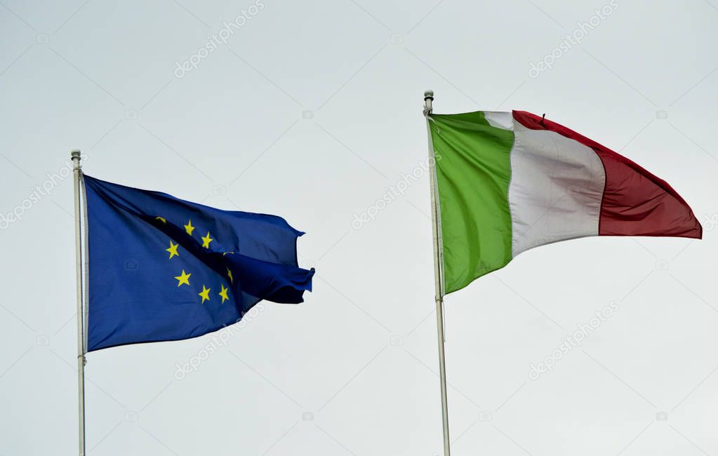 italian and european flag waving in the wind for the eu election day 