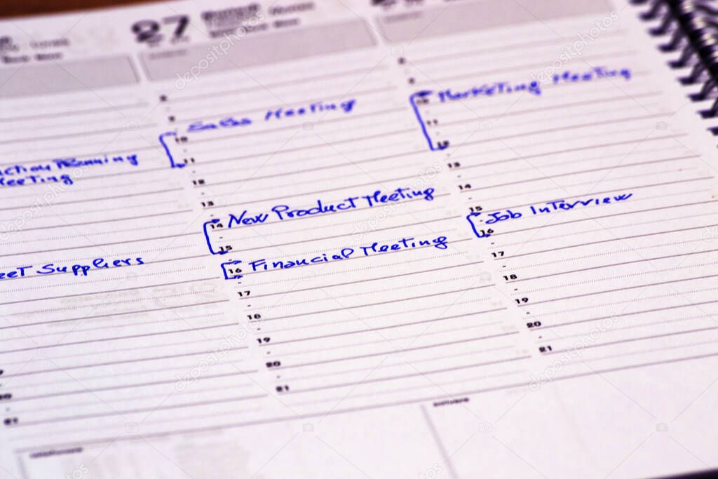 scheduling meeting time on a notepad to fix a business meeting. concept for business, job applications